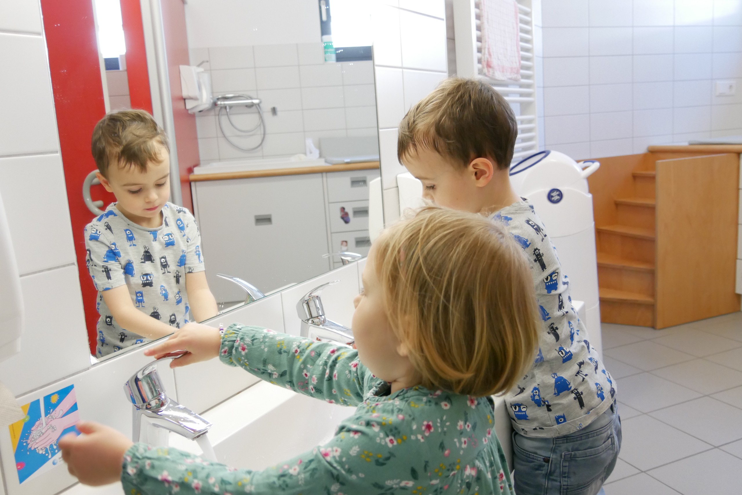 Kinder waschen sich die Hände im Bad